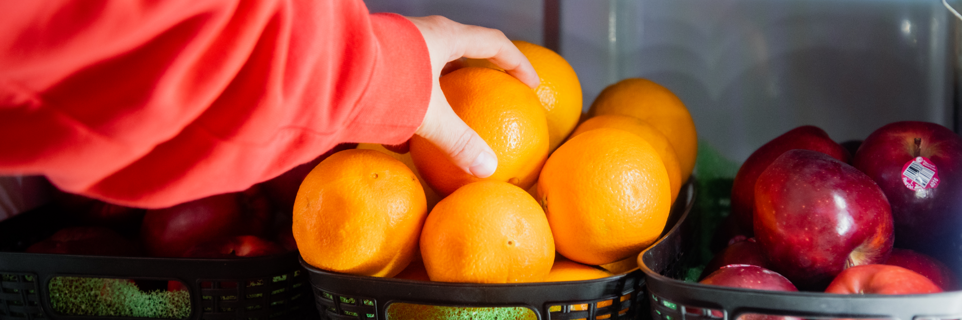 hand grabbing an orange